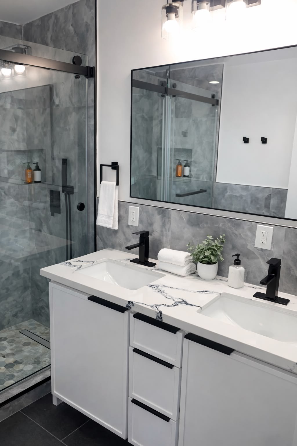 Finished bathroom vanity with white cabinetry, a marble countertop, large framed mirror, and black fixtures