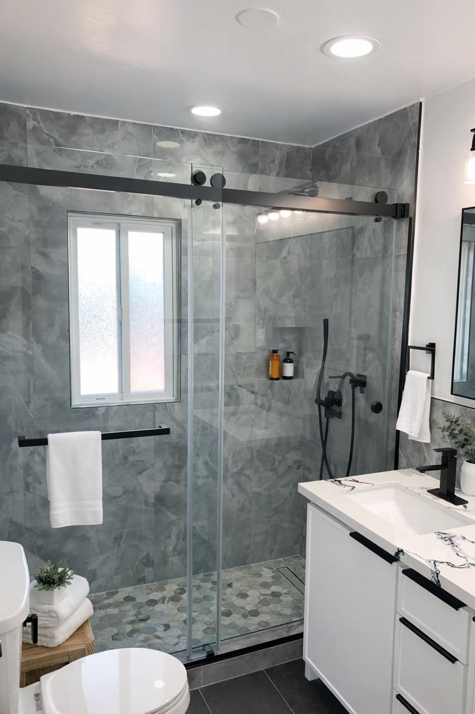Completed bathroom with a frameless glass shower and a floating vanity