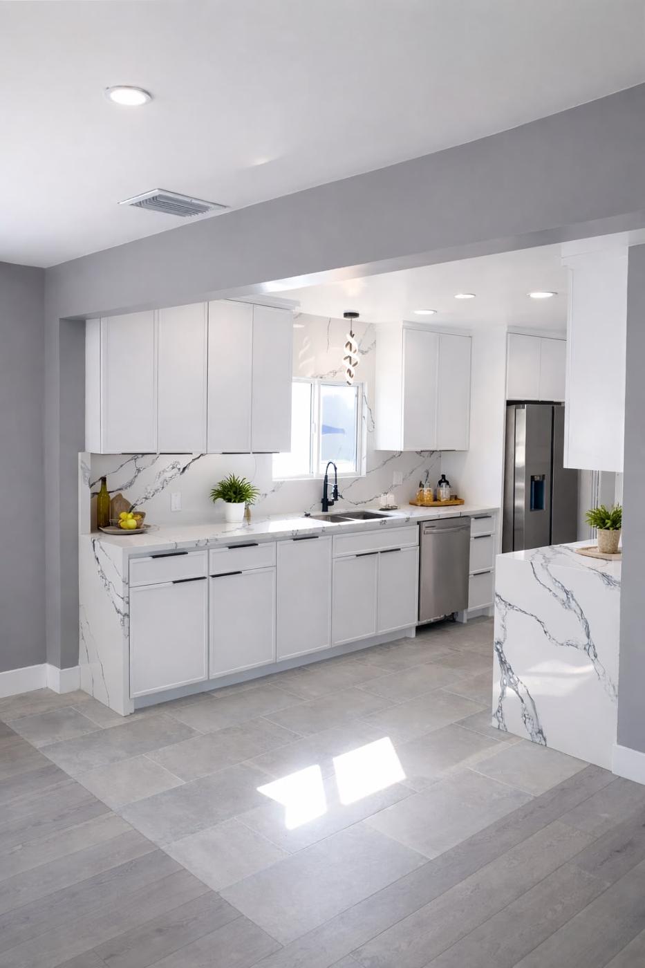 Remodeled kitchen with crisp white cabinetry and clean modern lines
